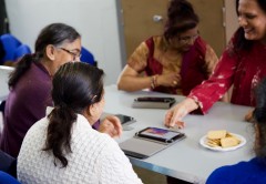 Community members at the Adhar Project learn how to use their new tablet computers